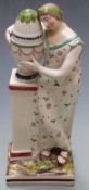 19thC Staffordshire creamware figurine of a lady beside a pedestal jardiniere