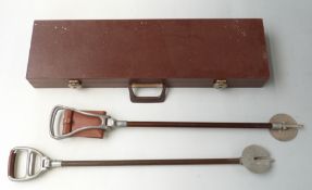 Shotgun hard carry case with felt lined interior, 80 x 22 x 9cm, together with two shooting sticks