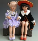Two Jan McLean seated artist's dolls both with closed mouths, fixed blue eyes, articulated neck