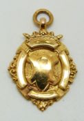 A 9ct gold military football or similar sporting medal, engraved verso KLC, 5.0g