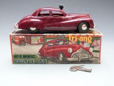 Tri-ang Minic clockwork tinplate Police Car with maroon body, brown interior, loudspeaker and