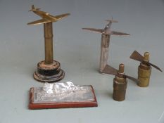 Four trench art pieces, two in the form of a Spitfire, the other two propellers on bases together