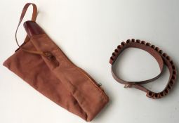 Canvas and leather wool lined gun slip with shoulder strap and a brown leather 12 bore shotgun