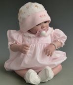 Sheila Michael Reborn doll with fixed blue eyes, magnetic dummy and pink outfit, 44cm tall.