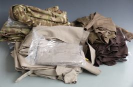 Military clothing including camouflage jackets, shirts, some in multi terrain pattern, some in