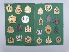 Twenty three c1930's Australian army head-dress badges including Hunter River Lancers. Sydney