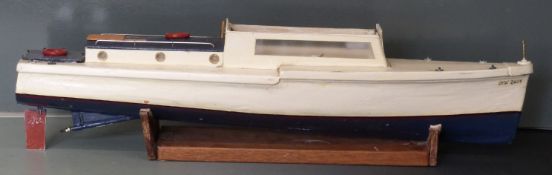 Two model remote control boats, one with motor fitted.