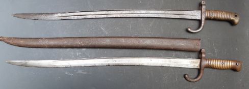 Two French Army 1866 pattern bayonets with yataghan 57cm blades one with scabbard, one named St