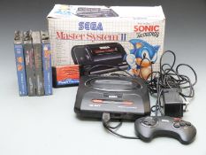 Two Sega video games consoles Master System II in original box and Mega Drive II together with