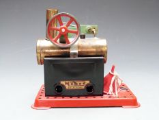 Mamod stationary live steam engine with single cylinder and Meccano style base.