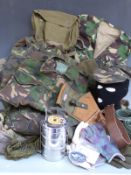 A collection of camouflage clothing and accessories including t-shirts, trousers, jackets, gloves,