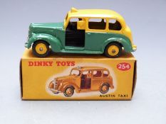 Dinky Toys diecast model Austin Taxi with green and yellow body and yellow hubs, 254, in original