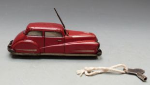 Schuco clockwork tinplate car with red body and opening bonnet, 2002.