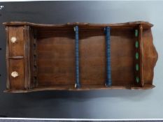 An oak gun rack with two drawers and antler handles. W56xD25xH135cm