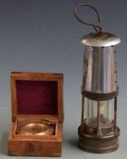 Miner's lamp and cased compass