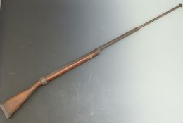 British sprung bayonet training or practice rifle with wooden stock stamped 1915, 161cm long.