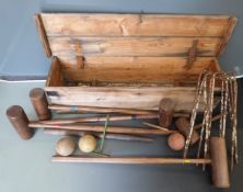 A vintage croquet set with turned oak/ash handles and wrought iron hoops, in original crate.