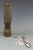 WWI trench art in the form of a crimped shell together with a piece of shrapnel and barbed wire from