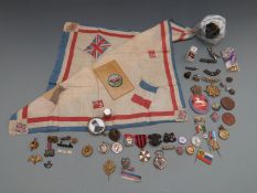 A small collection of military badges, lapel pins, buttons etc