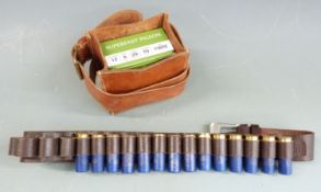 Thirty-four 12 bore shotgun cartridges together with a leather cartridge belt and similar