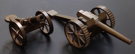 Two brass desk cannon one with 7 inch graduated octagonal barrel, overall length 31cm the other with