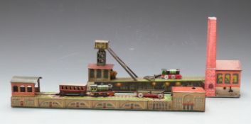 Two Arnold clockwork tinplate railways, one in the form of a coal mine with engine shed, the other