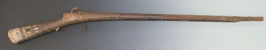 Eastern matchlock hammer action gun with bone inlaid stock and 37 inch flared octagonal barrel,