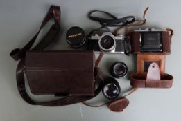 Canon AV1 SLR camera with 50mm 1:1.8 and 135mm 1:3.5 lenses and Panagor macro converter together