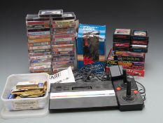 Atari 2600 video games console together with 47 various Atari and Commodore games and cartridges,