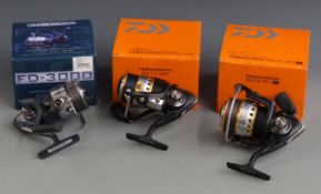 Three fixed spool fishing reels in boxes including Daiwa Match 3012D, 2508 and a Drennan FD-3000