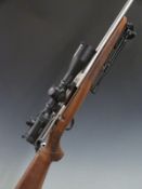 Tikka T3 .243 bolt action rifle with chequered semi-pistol grip and forend, folding bi-pod, sling