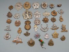 British military and other cap badges including hallmarked silver ARP badge