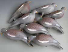 Eight plastic pigeon decoys, some with stick mounts