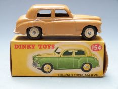 Dinky Toys diecast model Hillman Minx Saloon with brown body and cream hubs, 154, in original box.