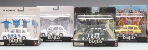 Four Corgi The Beatles Album Cover diecast model London taxis, all in original display boxes.
