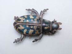 German tinplate beetle or similar insect raised on three wheels with moving legs, stamped 'Germany