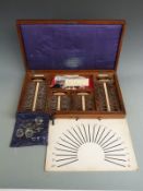 Cased set of optician's trial lenses in mahogany case with spectacles/holders, two May