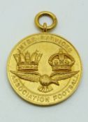 A 9ct gold Inter-service Association Football medal with eagle below two crowns, engraved verso