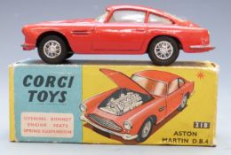 Corgi Toys diecast model Aston Martin D.B.4 with red body and lemon interior, 218, in original box.