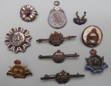 A small collection of silver and enamel Regimental badges etc to include Army Cyclist Corps, West