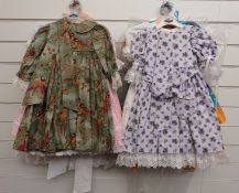 Eight various girls' or dolls' dresses many with floral and animal patterns and lace decoration