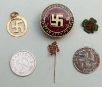 A quantity of swastika badges including National War Savings Committee