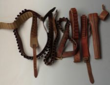 Six shotgun cartridge belts including 12 bore and .410 together with a rifle scope in leather case.