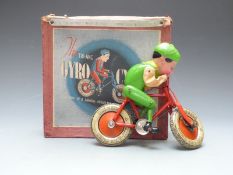 Tri-ang Gyro Cycle with red bike and green rider, in original box.