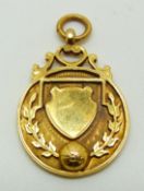 A 9ct gold military football medal with ball in relief to front, engraved verso USL Chatham 1922-3