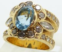 An 18ct gold ring set with a marquise cut aquamarine, marquise cut diamonds and round cut