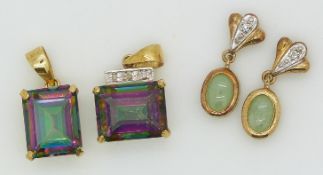 Two 9ct gold pendants set with mystic topaz, and two yellow metal pendants set with a quartz