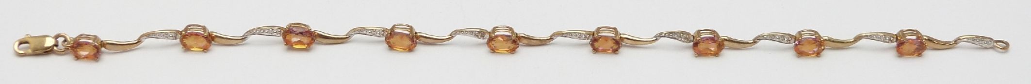A 9ct gold bracelet set with topaz and diamonds, 3.7g