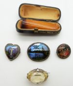 Two silver brooches set with butterfly wing, a citrine brooch and amber cheroot holder