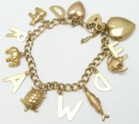 A 9ct gold charm bracelet with various charms including an elephant, turtle, fish, Victorian heart